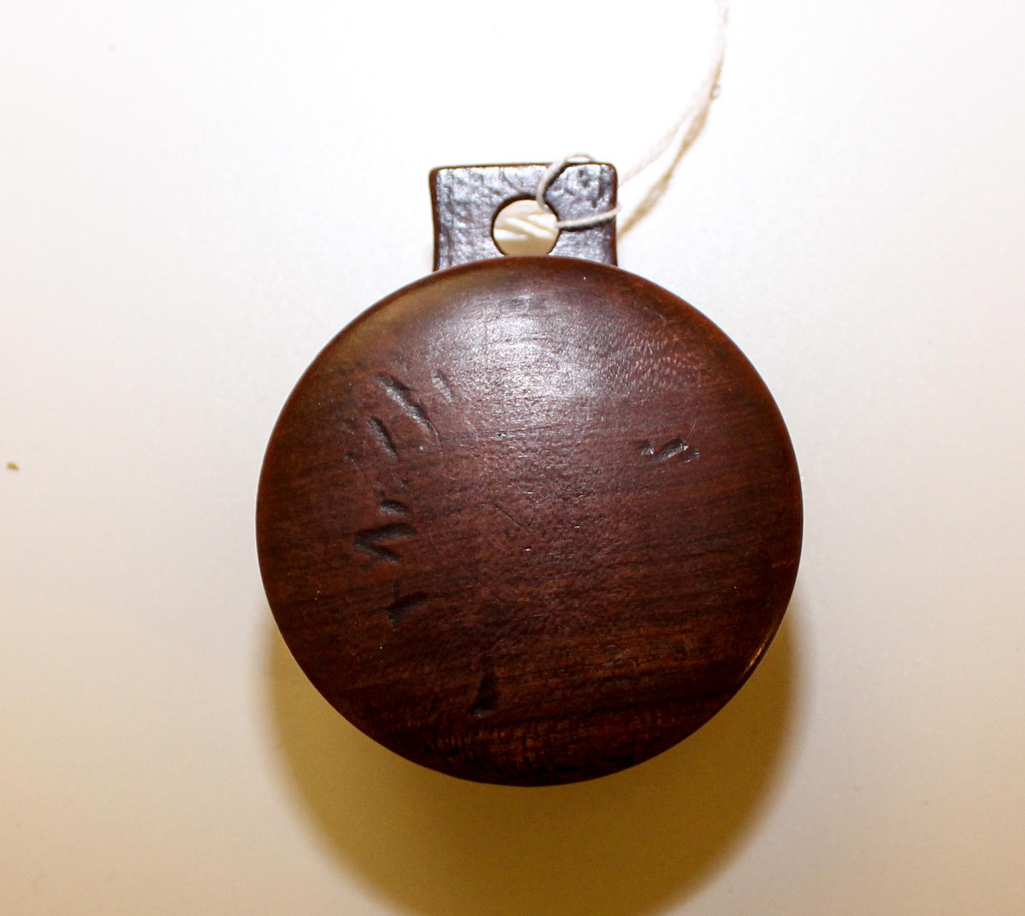 A Wooden Nutmeg Grater. Diameter 2 5/8 inches.