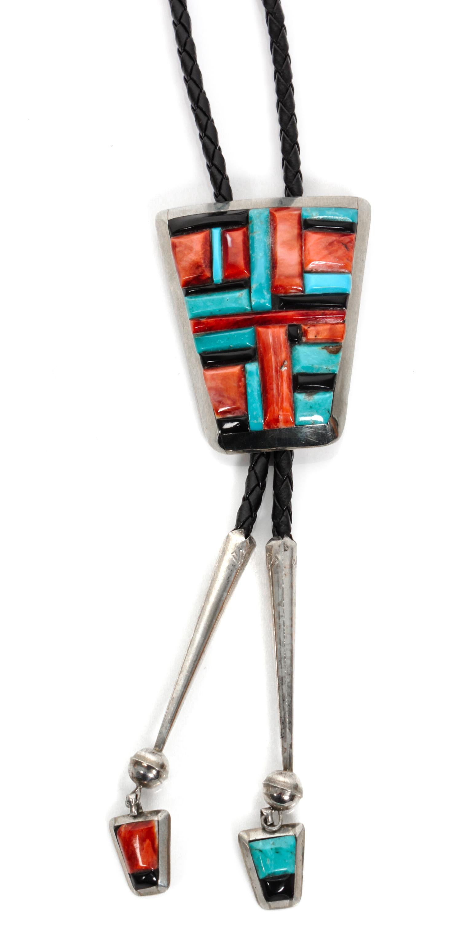 A Navajo Silver and Multiple Stone Bolo, Ben Begay Height 2 1/8 x width 1 3/4 inches.