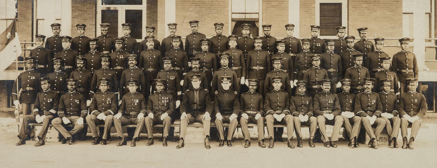 [BUFFALO SOLDIERS]. A group of 2 photographs of members of the 9th Cavalry, incl. Charles Young and George Prioleau. Fort D.A. Russell, Cheyenne, Wyoming, ca 1910s.