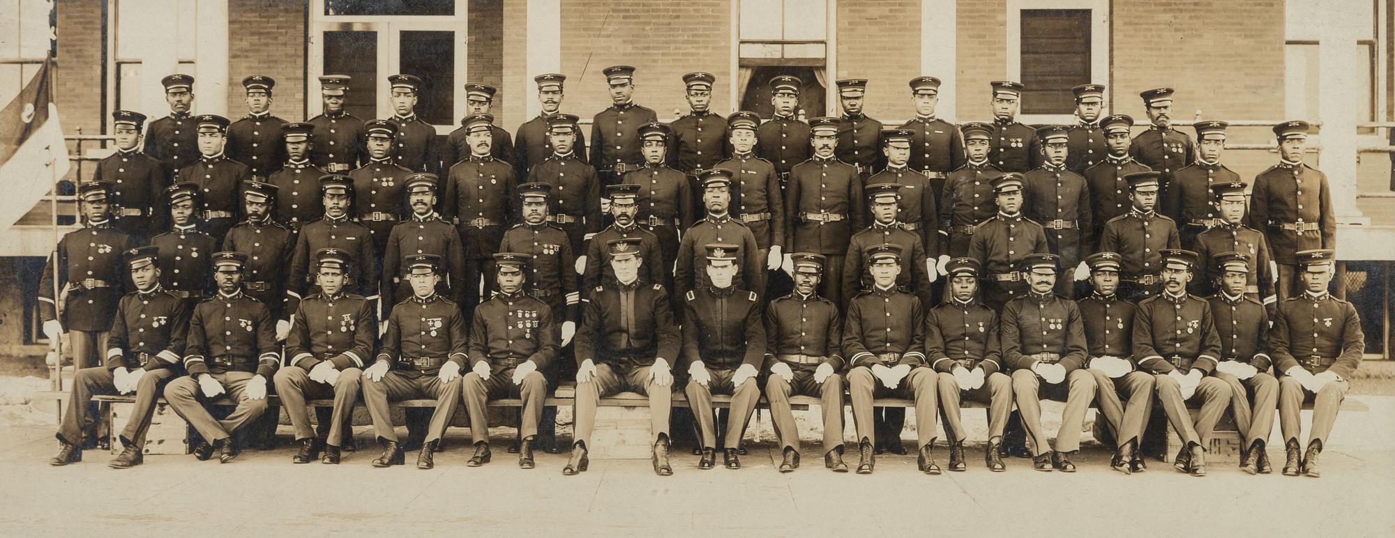 [BUFFALO SOLDIERS]. A group of 2 photographs of members of the 9th Cavalry, incl. Charles Young and George Prioleau. Fort D.A. Russell, Cheyenne, Wyoming, ca 1910s.