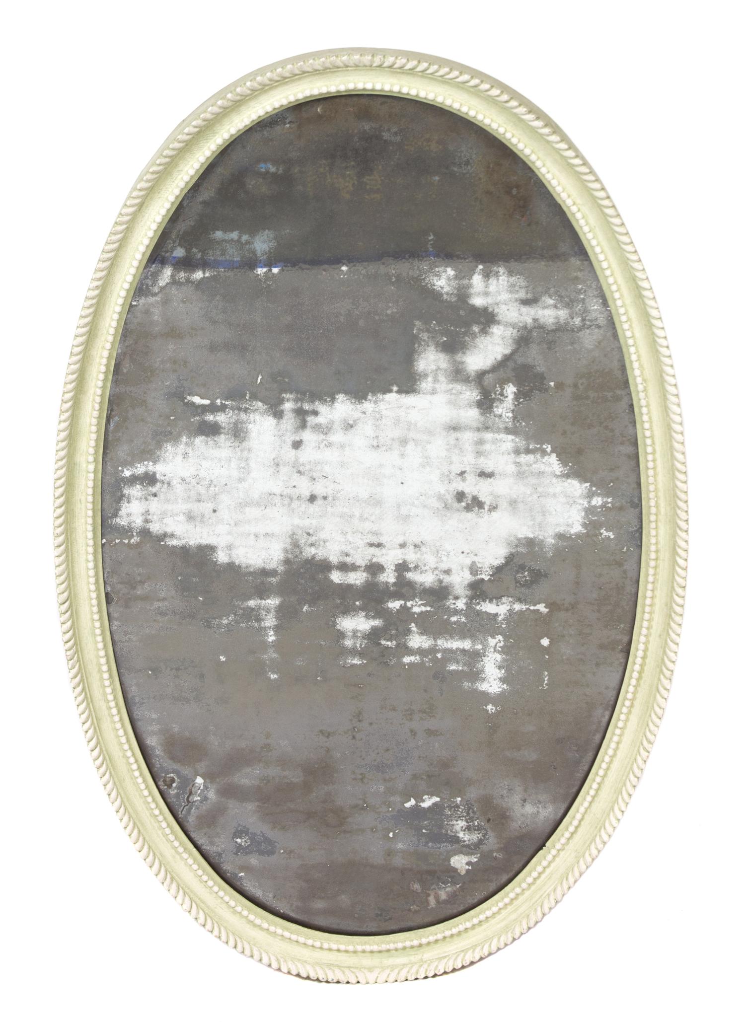 A Carved and Green Painted Oval Mirror Height 39 1/2 x width 24 inches. — 20TH CENTURY