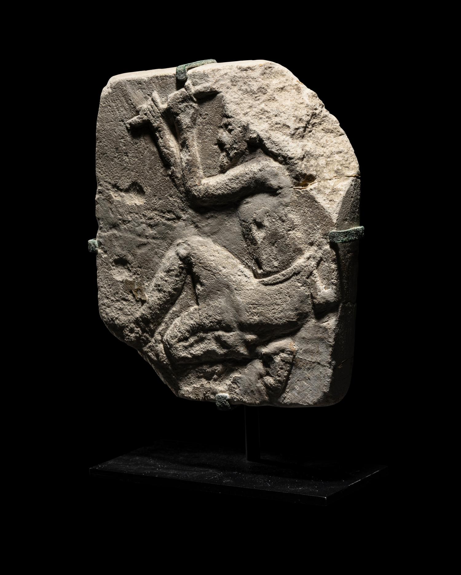 An Egyptian Limestone Relief of a Sculptor
