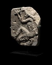 An Egyptian Limestone Relief of a Sculptor
