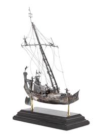 A Silver Model of a Chinese Junk, , applied with figures and realistic riggings, raised on a stepped base.