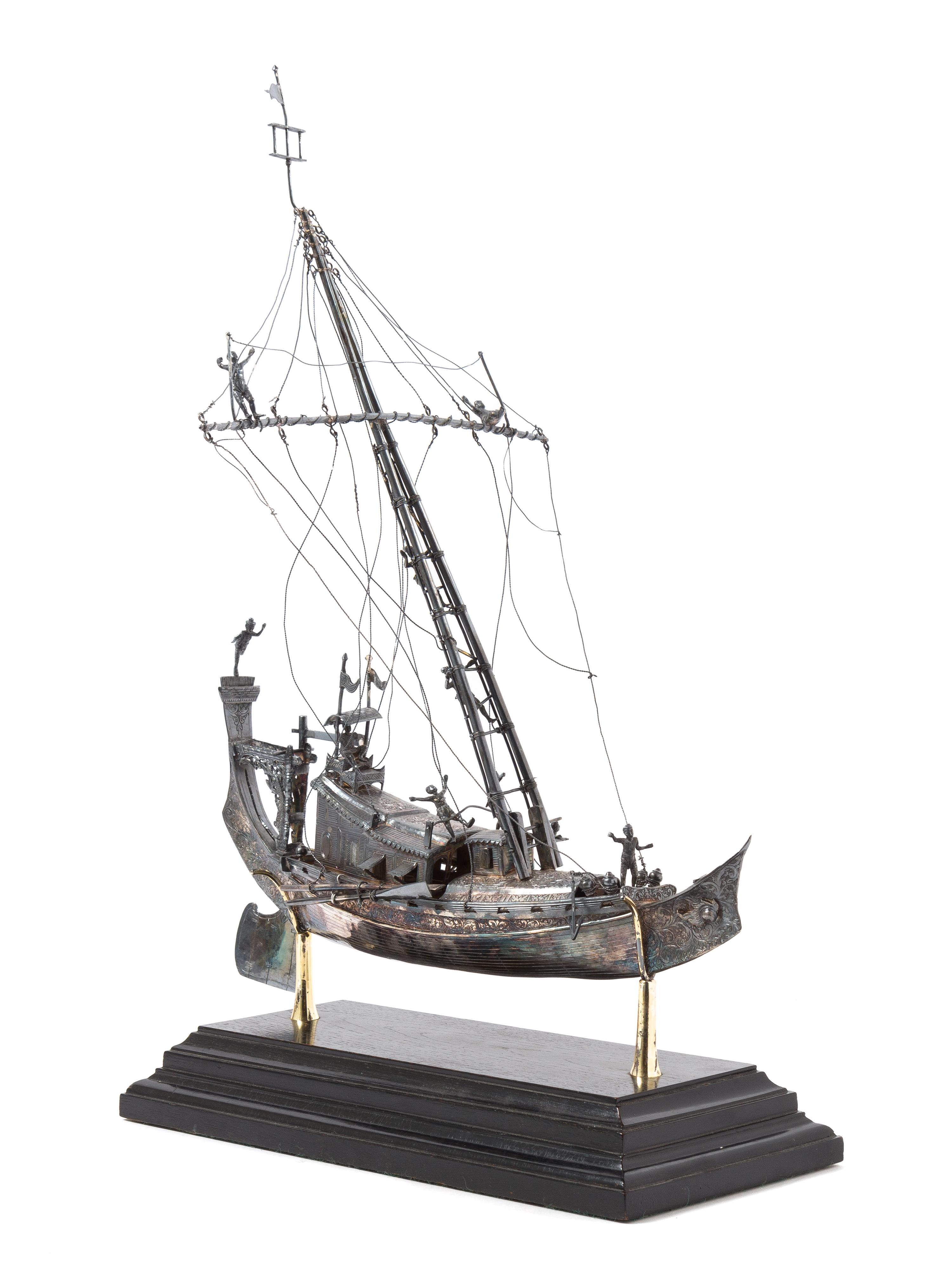 A Silver Model of a Chinese Junk, , applied with figures and realistic riggings, raised on a stepped base.