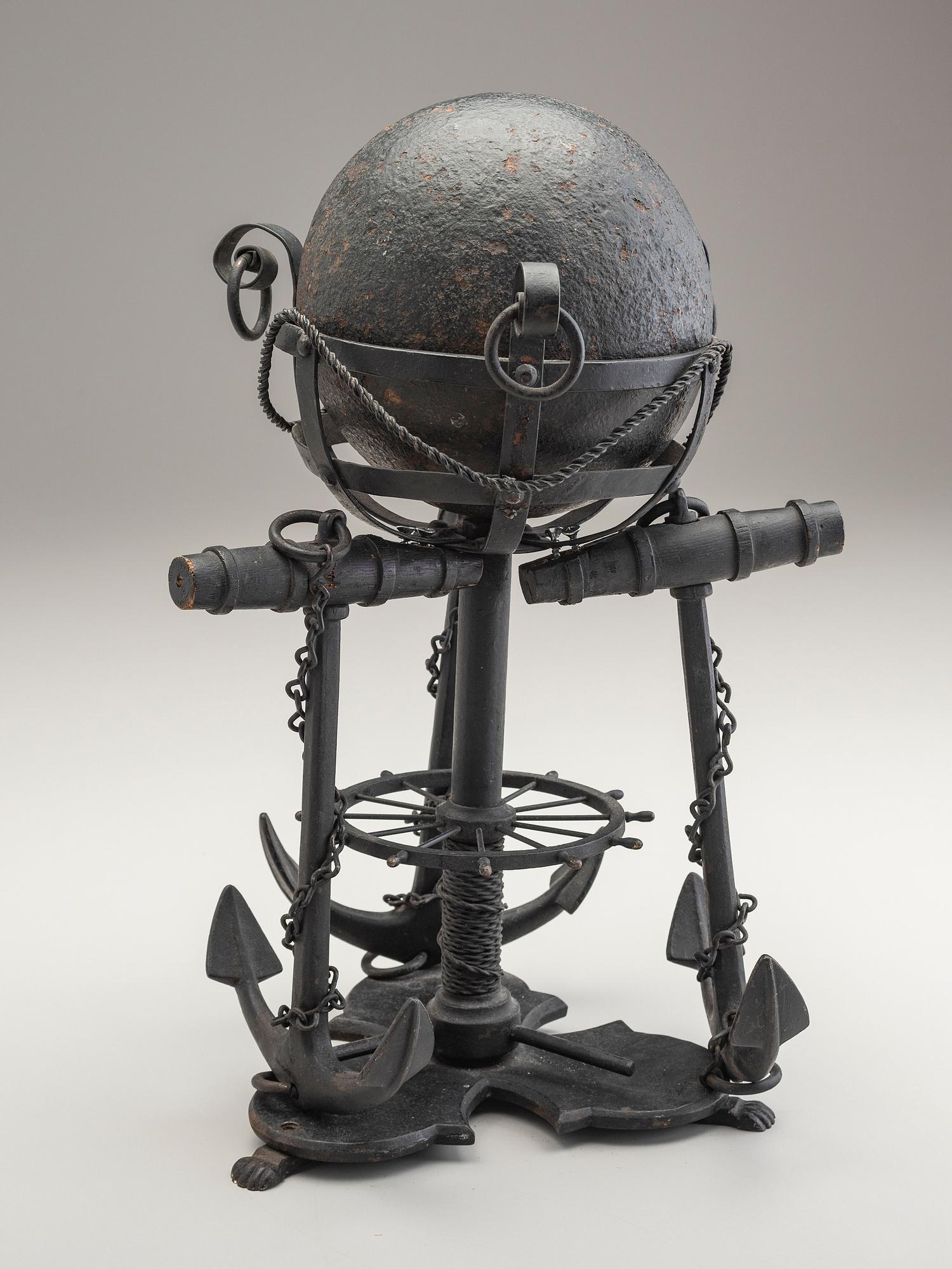 A Nautical Carved Wood and Iron Cannon Ball Stand