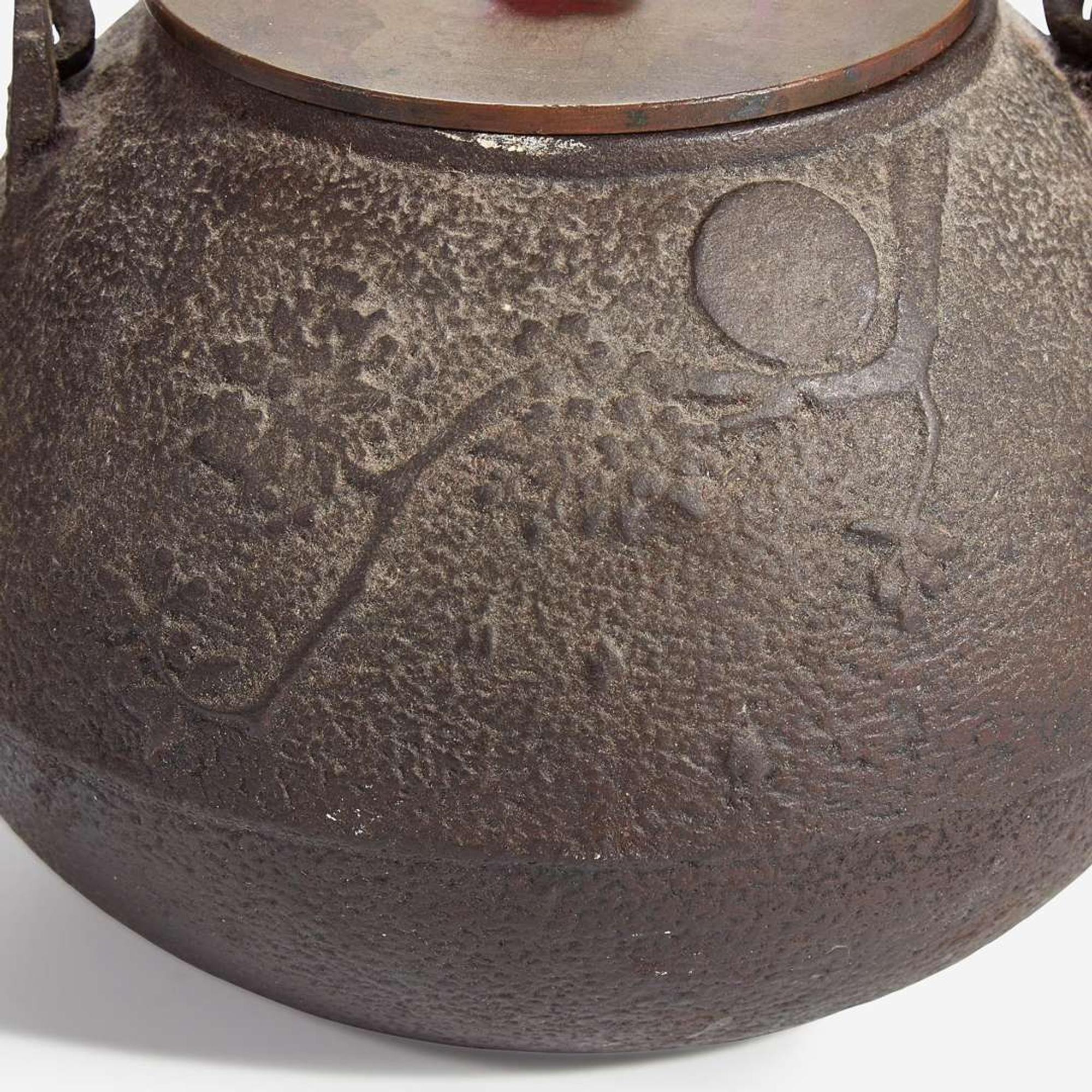 Two Japanese iron tetsubin with patinated bronze covers