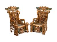 A Pair of Egyptian Revival Style Parcel-Gilt and Polychromed Throne Chairs
