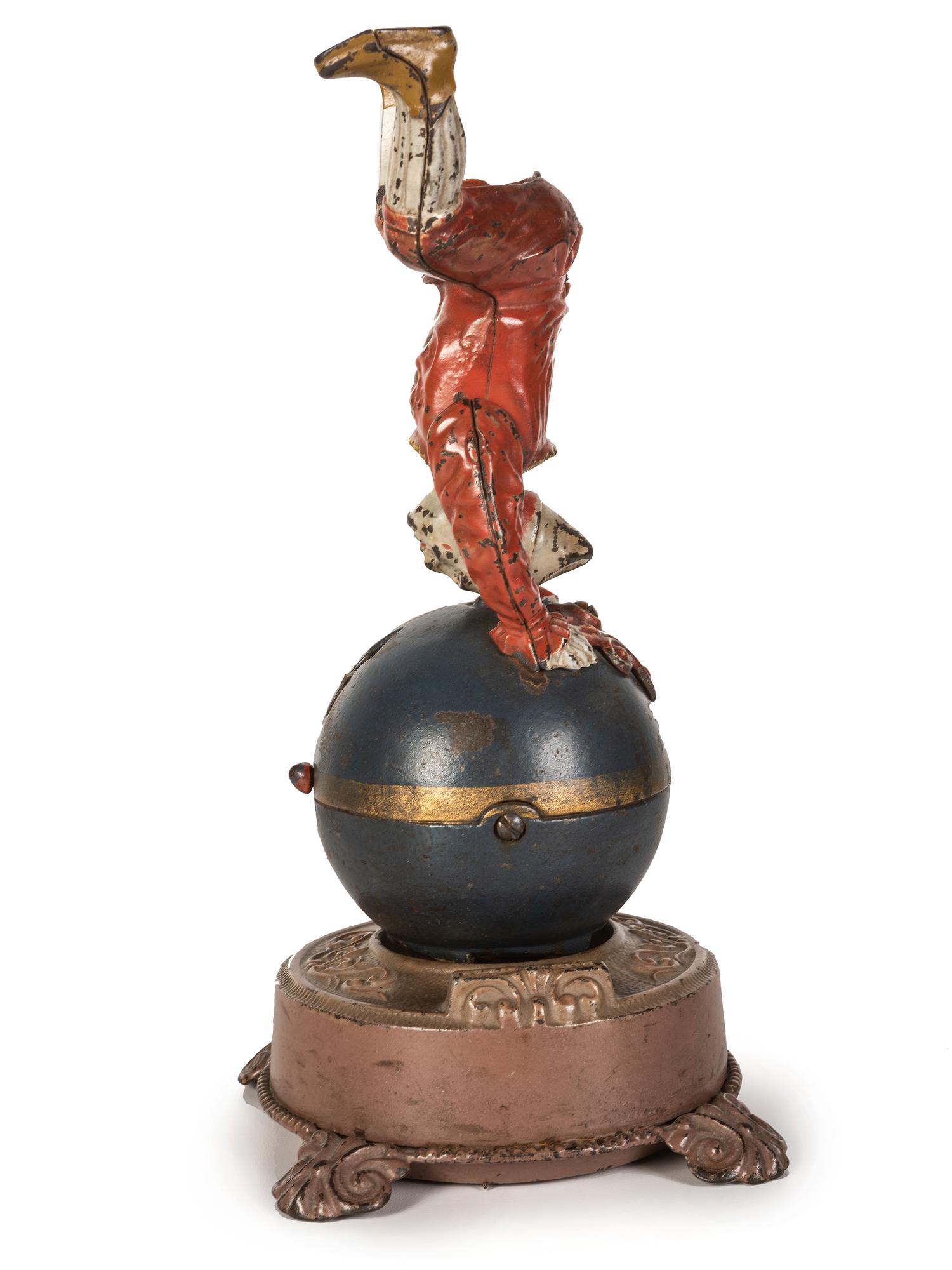 A Spinning Clown on Globe Cast Iron Mechanical Bank