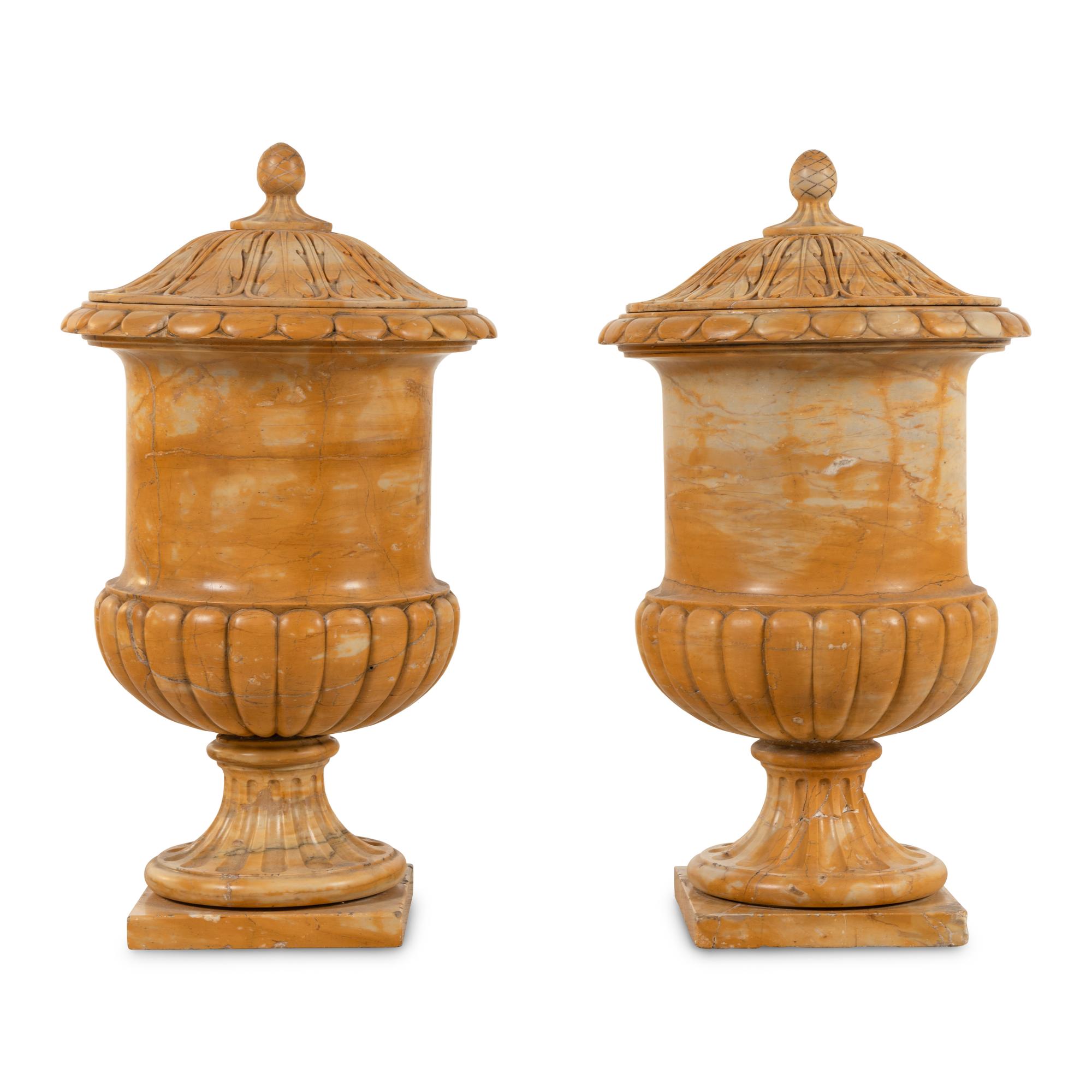 A Pair of Continental Carved Marble Covered Urns