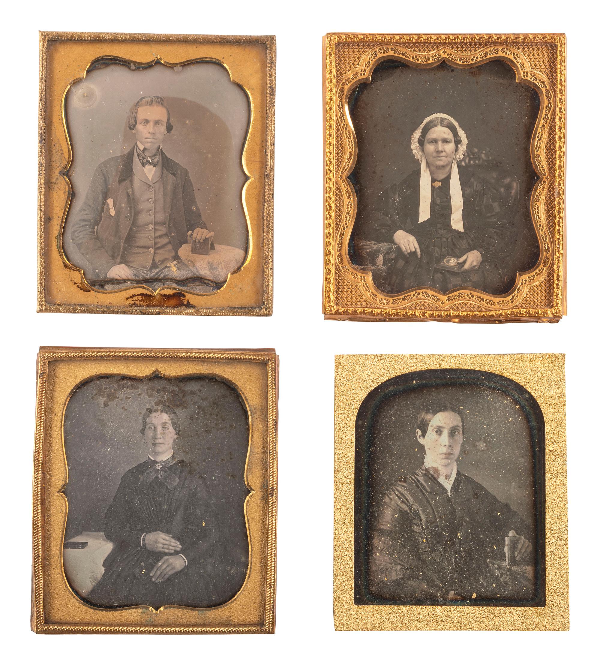 [EARLY PHOTOGRAPHY]. A group of 23 daguerreotypes featuring subjects posed with cased images, including: