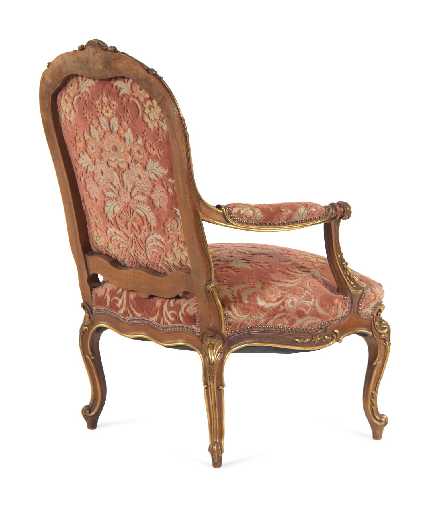 A Louis XV Style Carved and Parcel Gilt Walnut Fauteuil