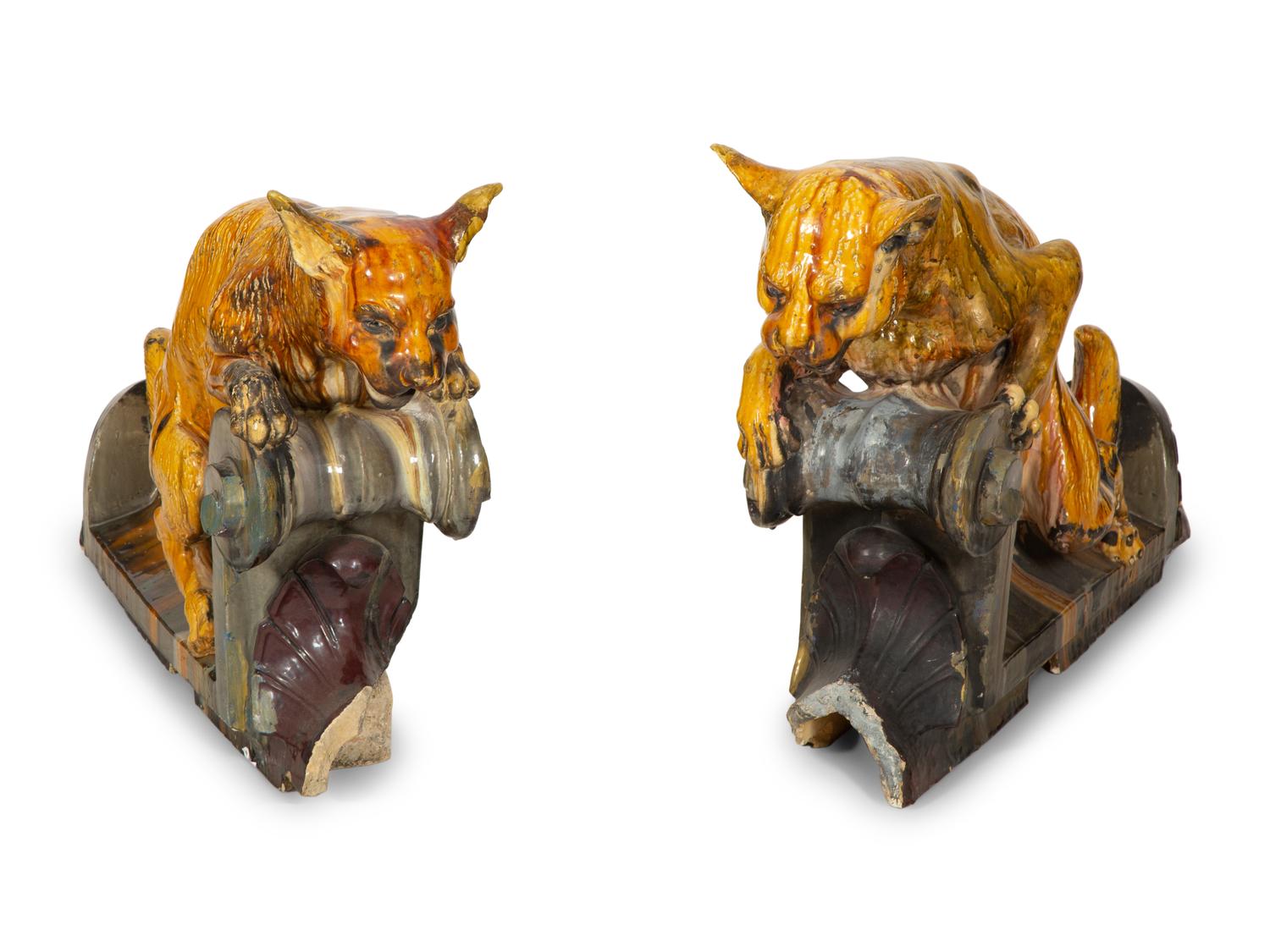 A Pair of Continental Glazed Terra Cotta Fox Roof Ornaments