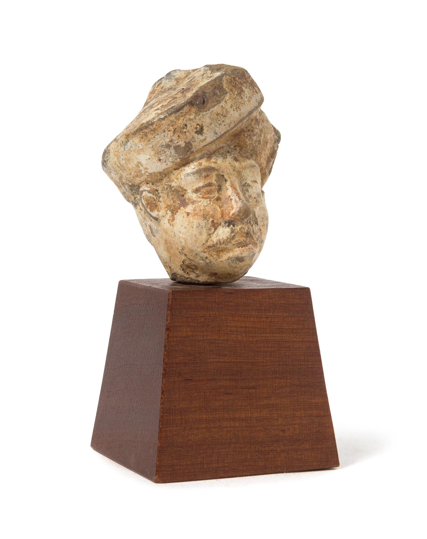 A Gandharan Stucco Head of a Male Height 2 3/8 inches.