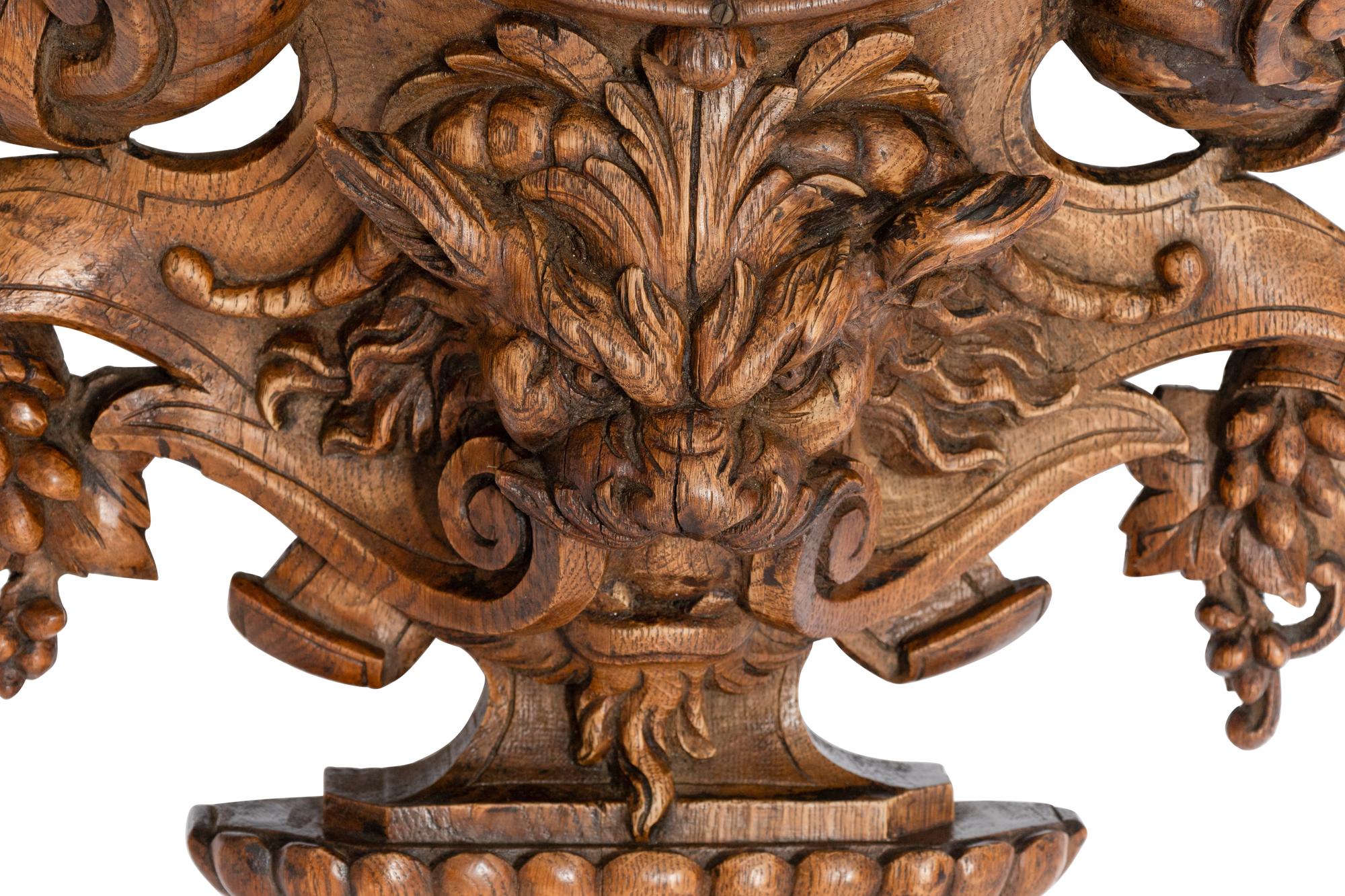 A Continental Carved Oak Figural Clock Case