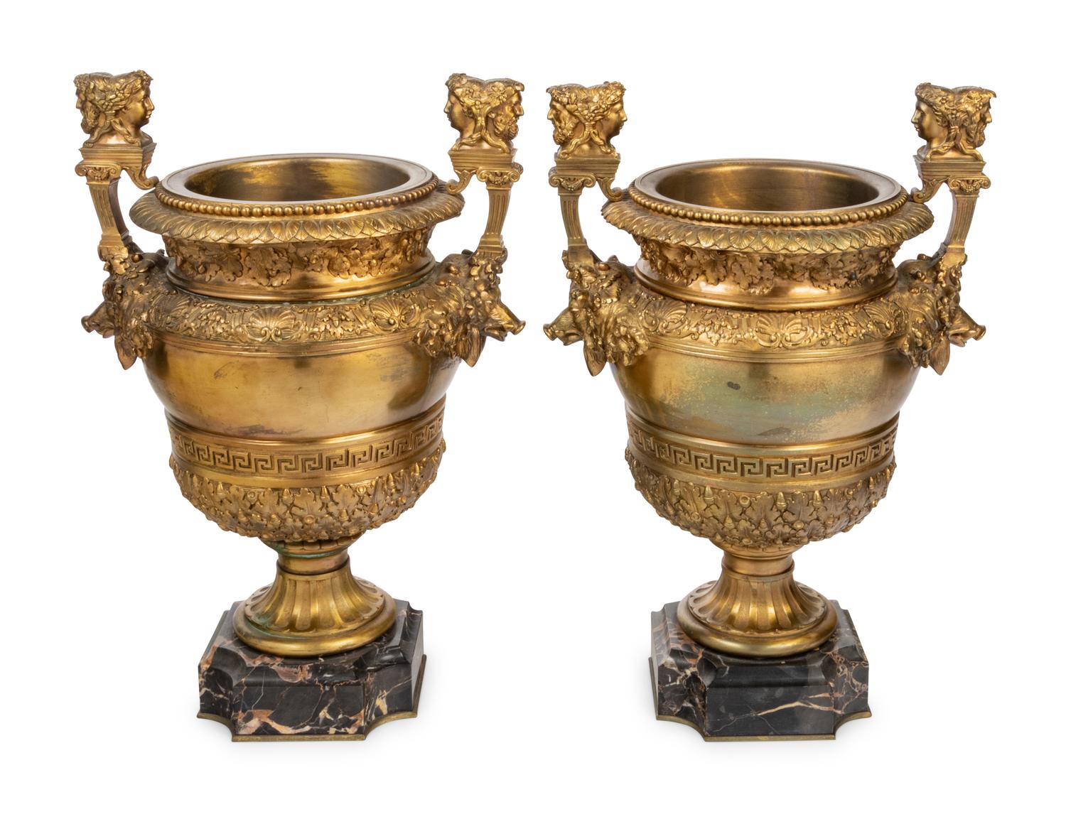 A Pair of Neoclassical Gilt Bronze Urns on Marble Plinths