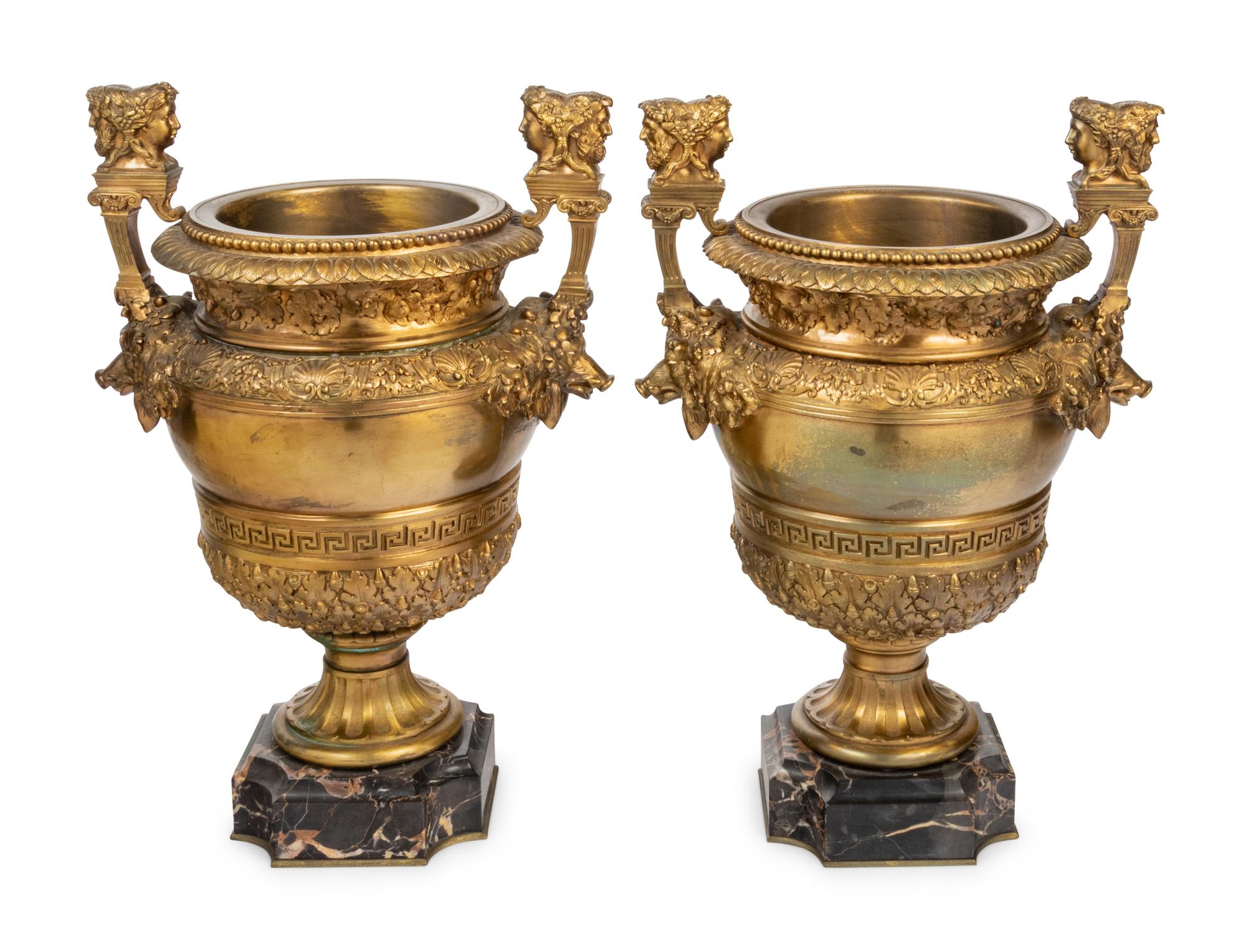 A Pair of Neoclassical Gilt Bronze Urns on Marble Plinths
