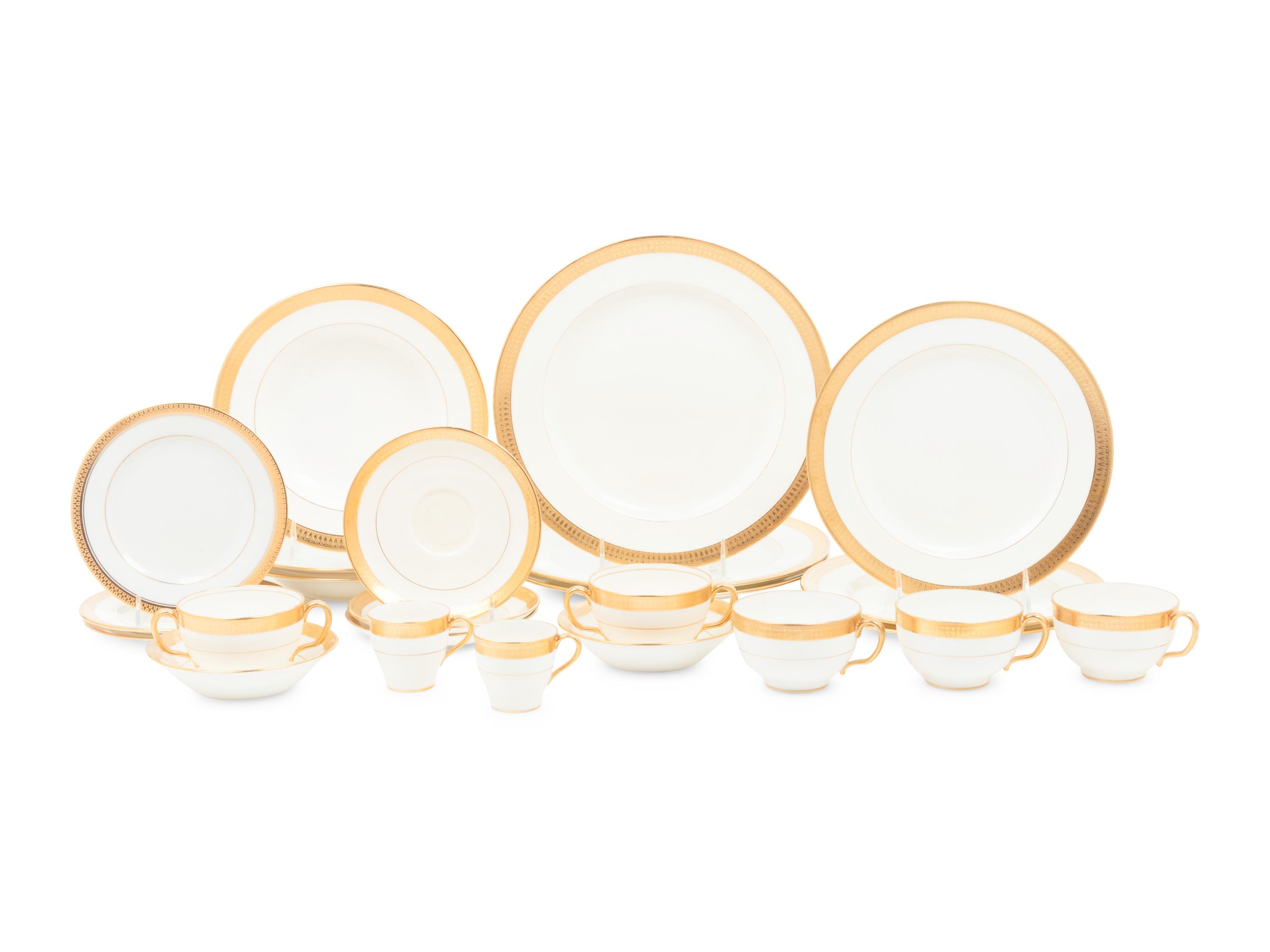 A Mintons Parcel Gilt Porcelain Dinner Service