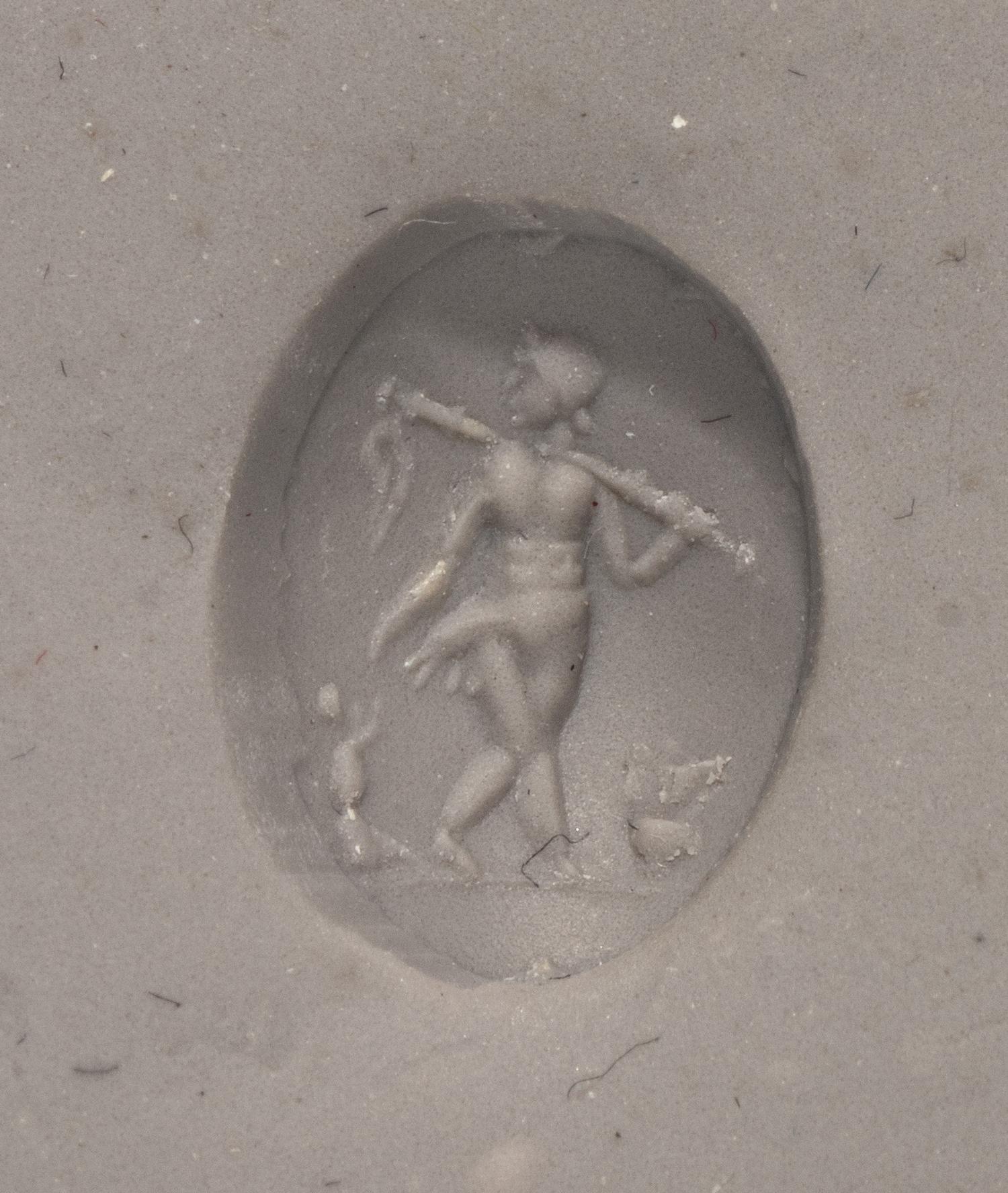 A Roman Rock Crystal Ring stone with the Gods Silenus and Infant Dionysus