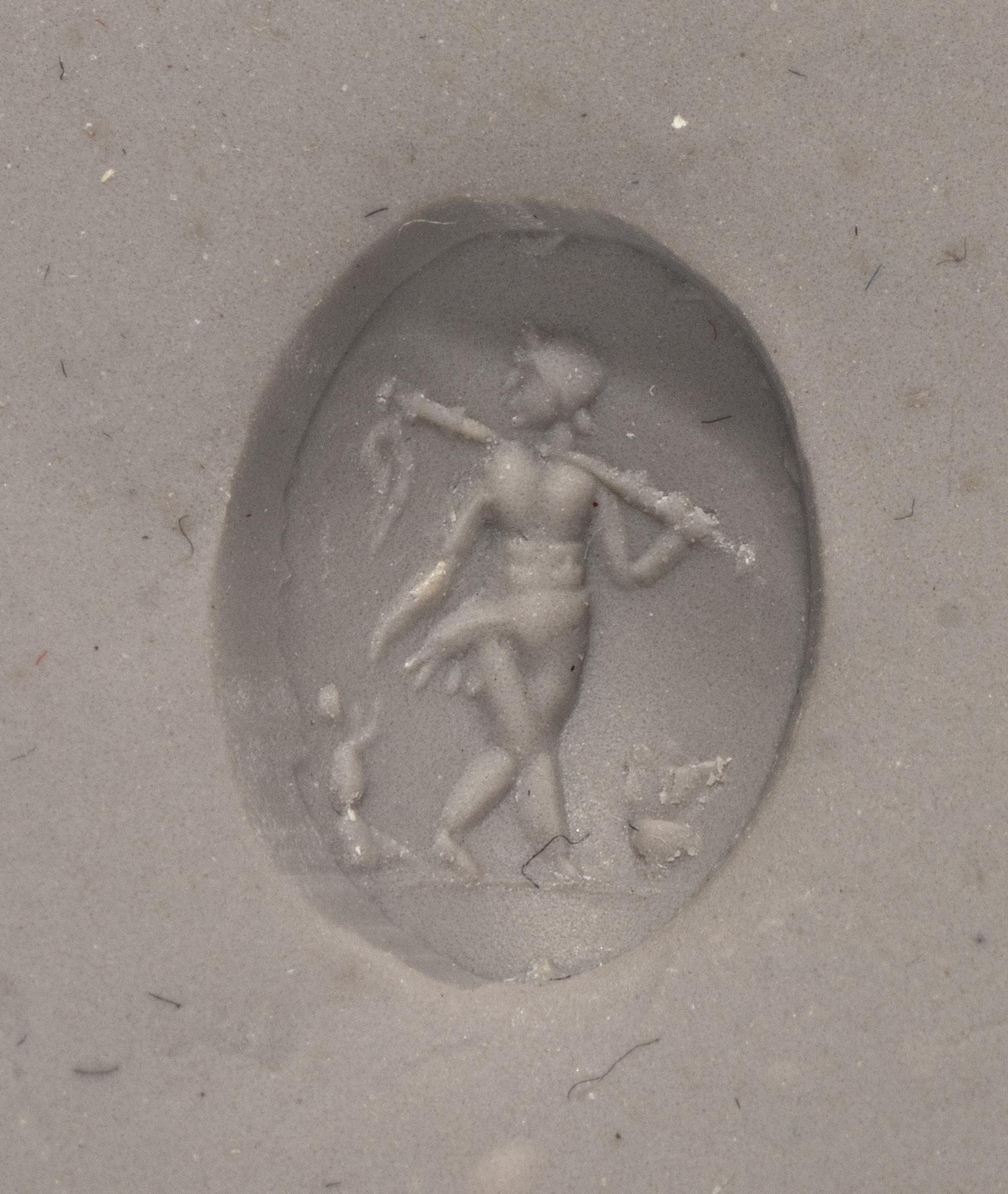 A Roman Rock Crystal Ring stone with the Gods Silenus and Infant Dionysus