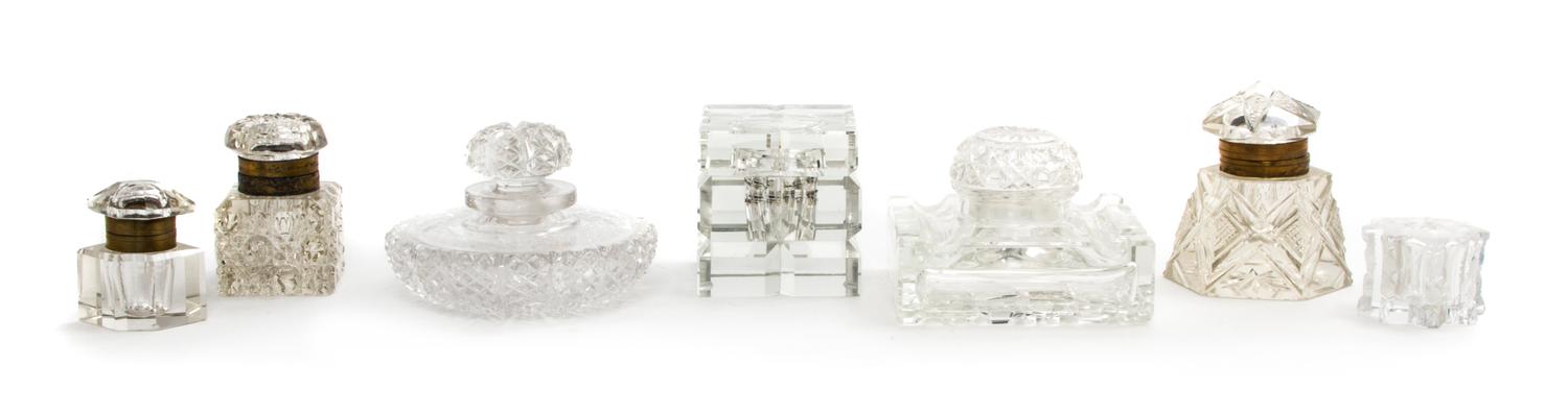 A Collection of Seven Cut Glass Paperweights, Width of widest 4 1/2 inches.