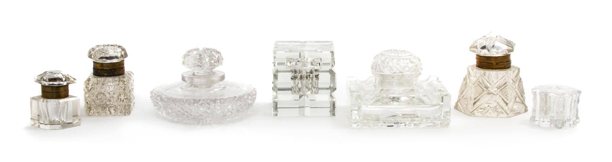 A Collection of Seven Cut Glass Paperweights, Width of widest 4 1/2 inches.