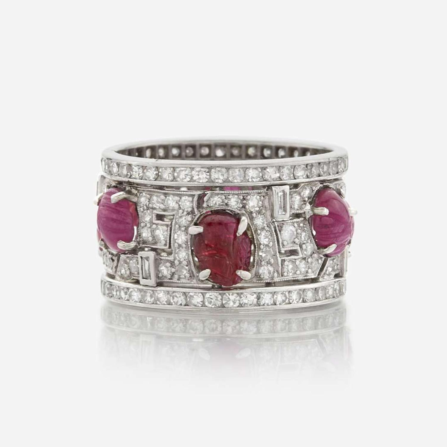 An Art Deco diamond, ruby, and platinum wide band