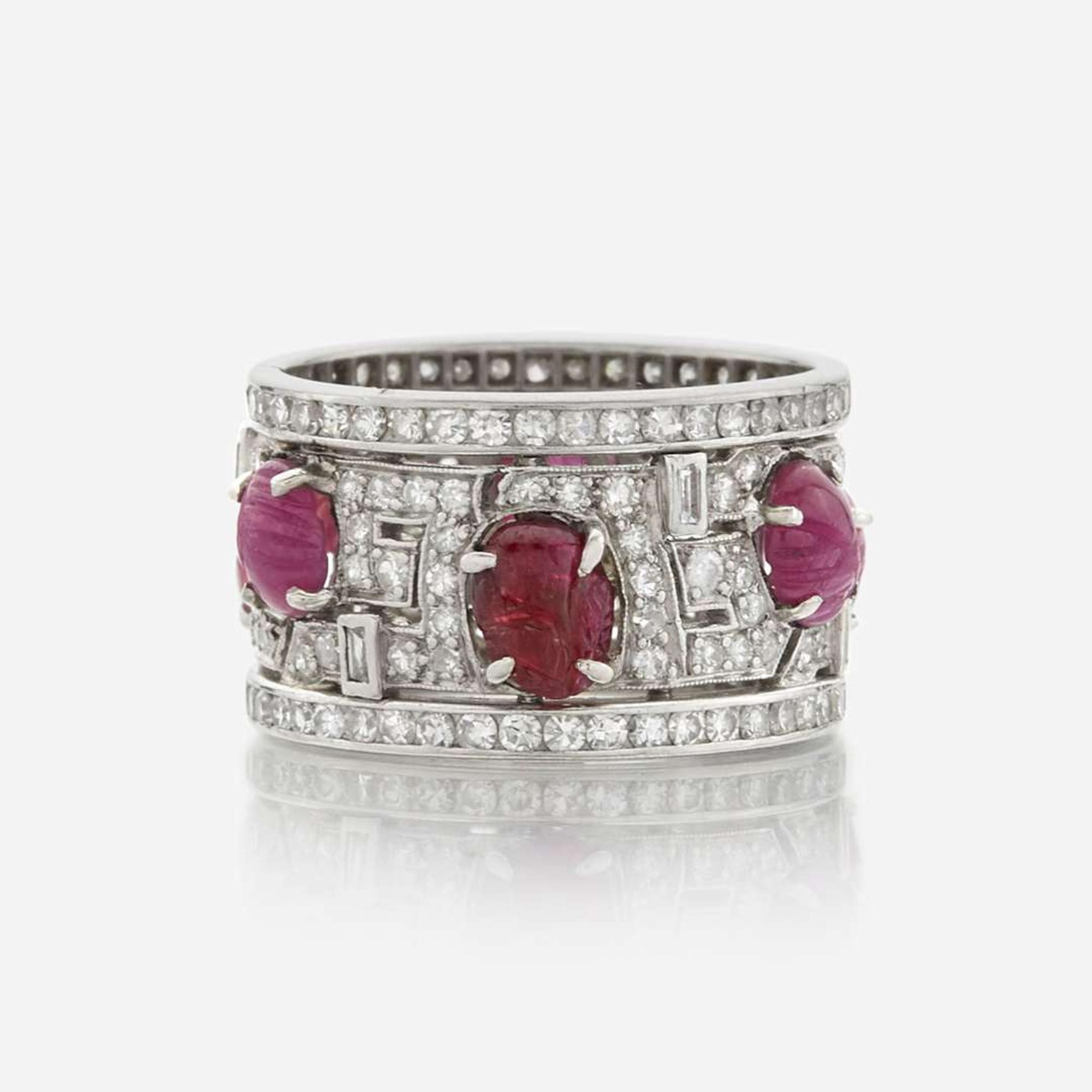An Art Deco diamond, ruby, and platinum wide band