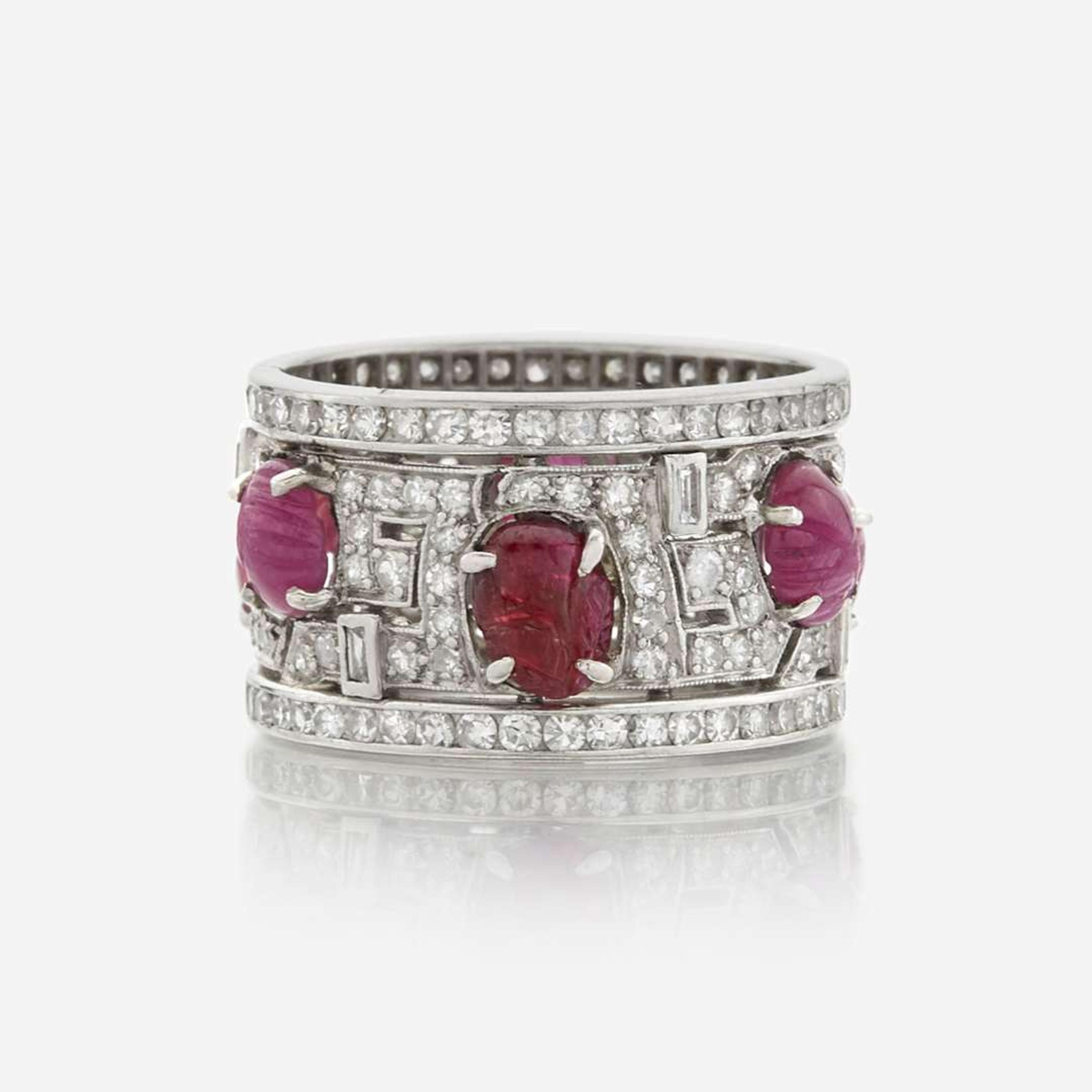 An Art Deco diamond, ruby, and platinum wide band