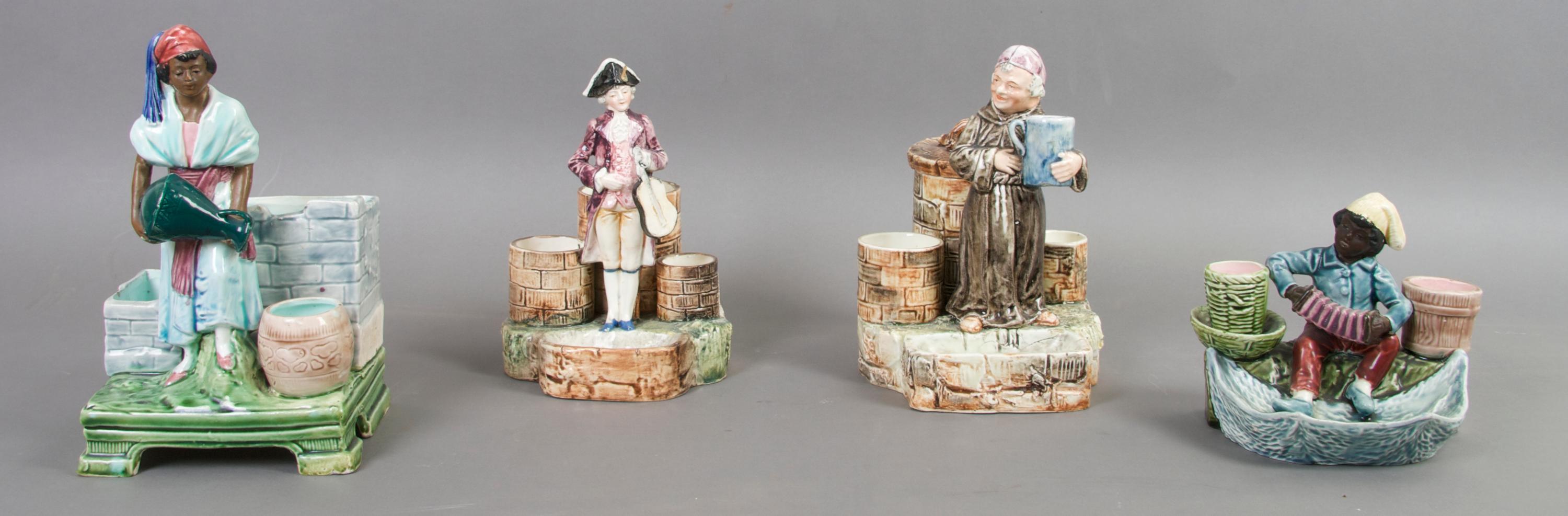 A Collection Four Figural Majolica Match Strikes, Height of tallest 8 3/4 inches.