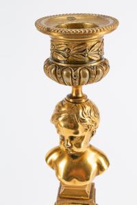 A Pair of Continental Gilt Metal Candlesticks with Busts of Children