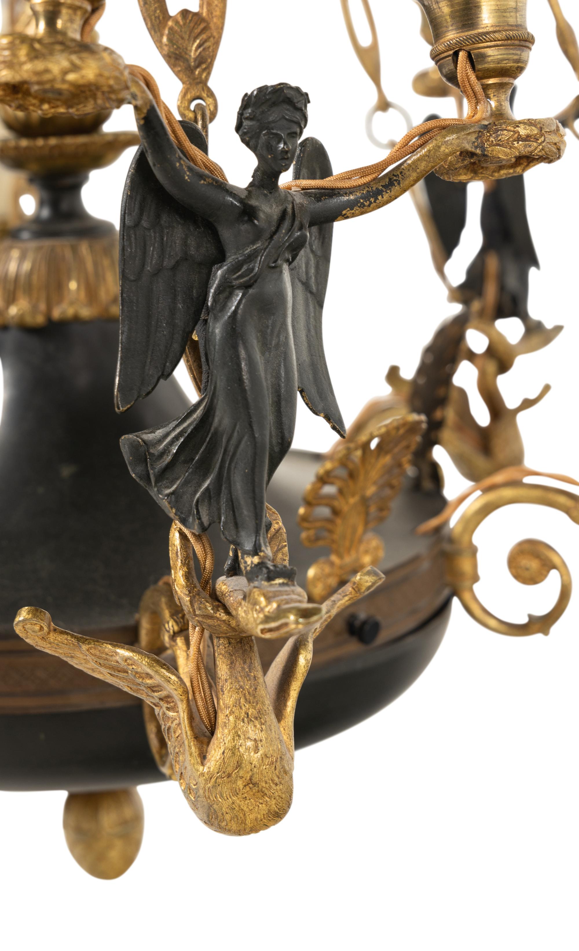 An Empire Style Gilt and Patinated Bronze Nine-Light Chandelier