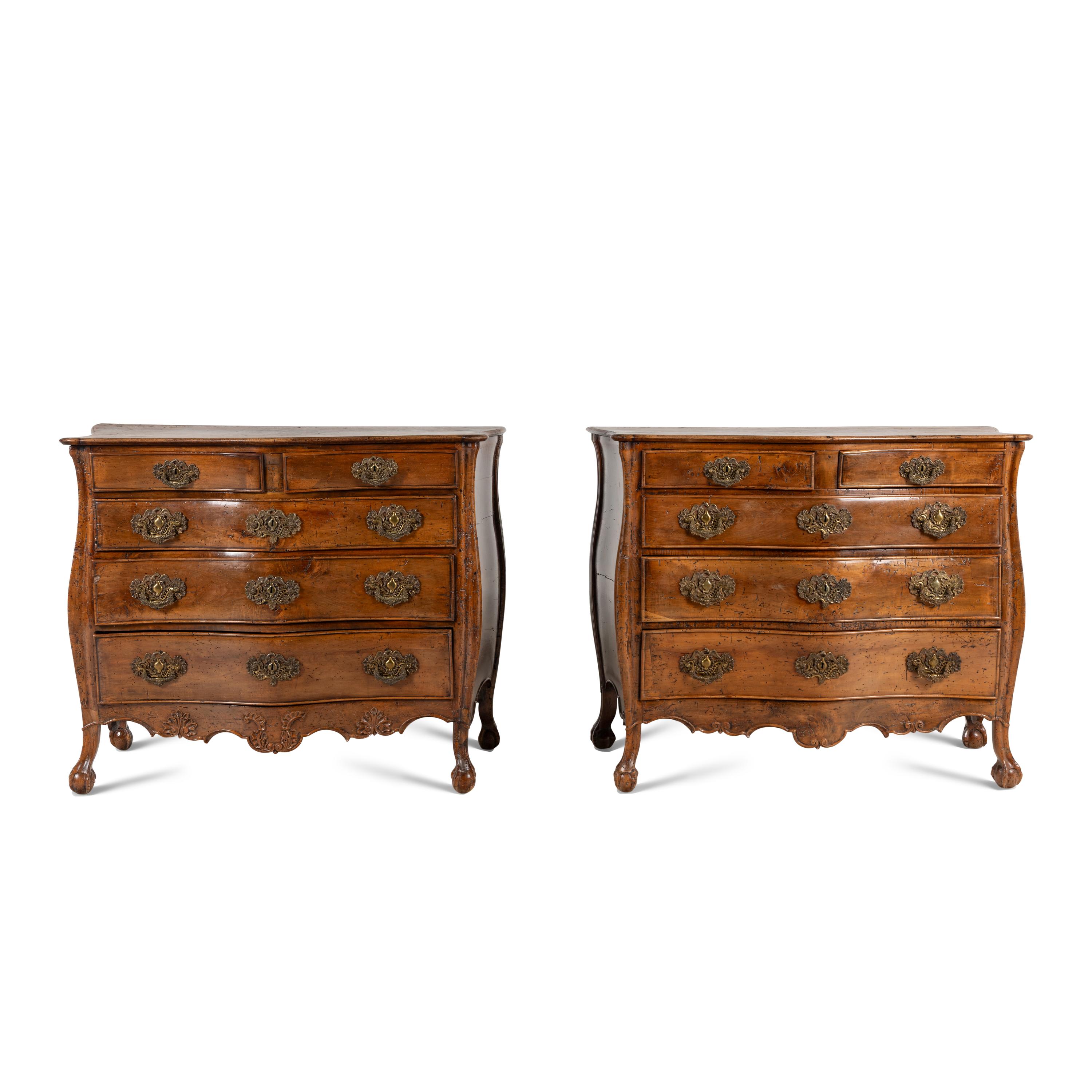 A Pair of Continental Walnut Chests of Drawers