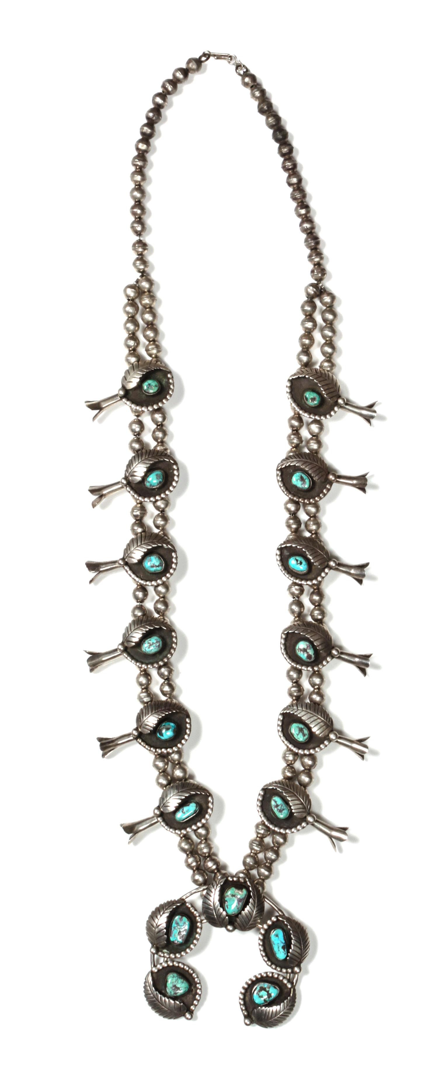 A Navajo Silver and Turquoise Squash Blossom Necklace, Bobby Thompson Length 32 inches; height of naja 2 1/2 x 3 inches.