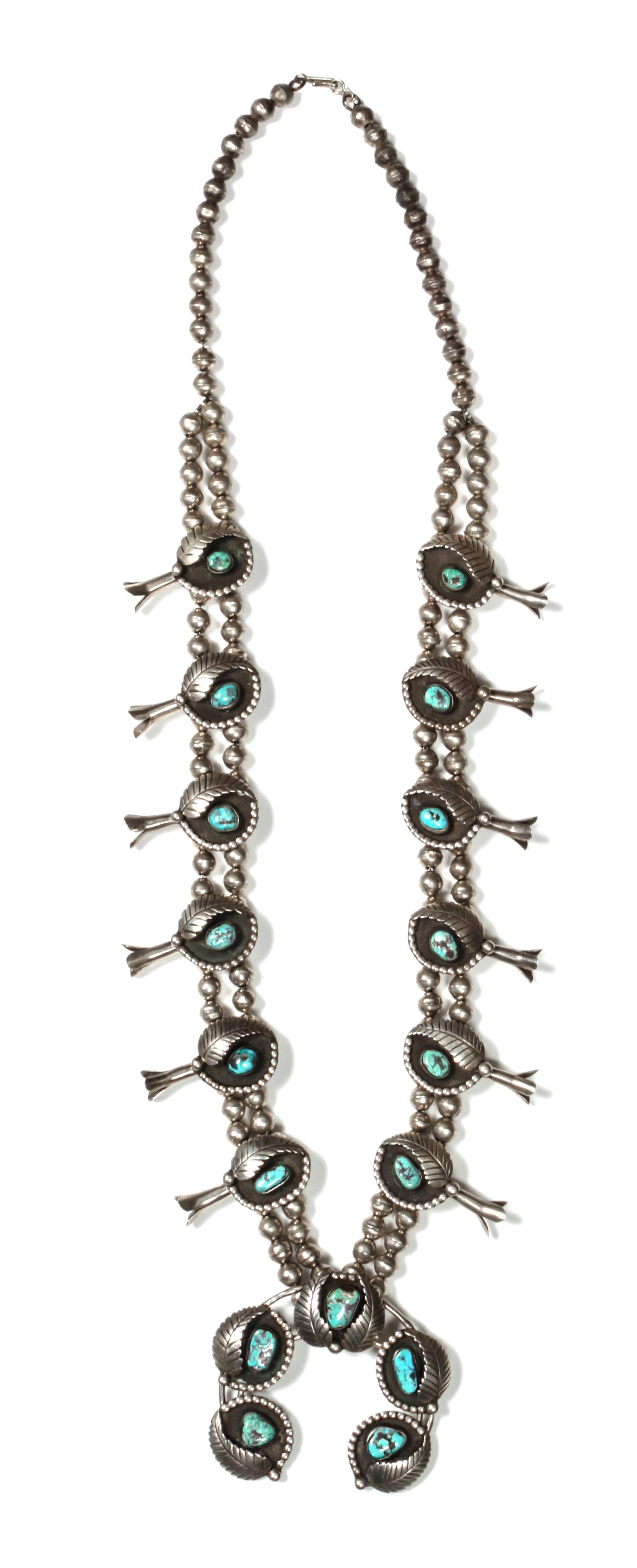 A Navajo Silver and Turquoise Squash Blossom Necklace, Bobby Thompson Length 32 inches; height of naja 2 1/2 x 3 inches.