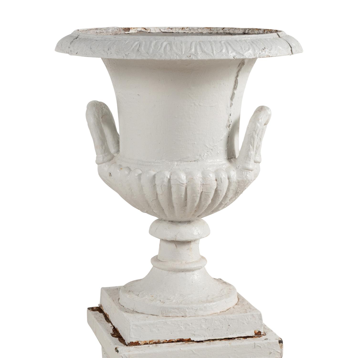 A Set of Three White Painted Iron Garden Urns