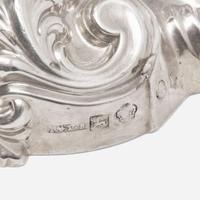 Three pairs of George III / Victorian weighted sterling silver candlesticks in the Rococo manner Various makers, Sheffield, dates ranging 1818-1846