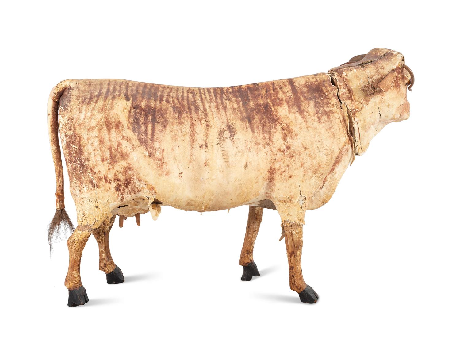 A Wood and Leather Mooing Cow-Form Pull Toy with Glass Eyes