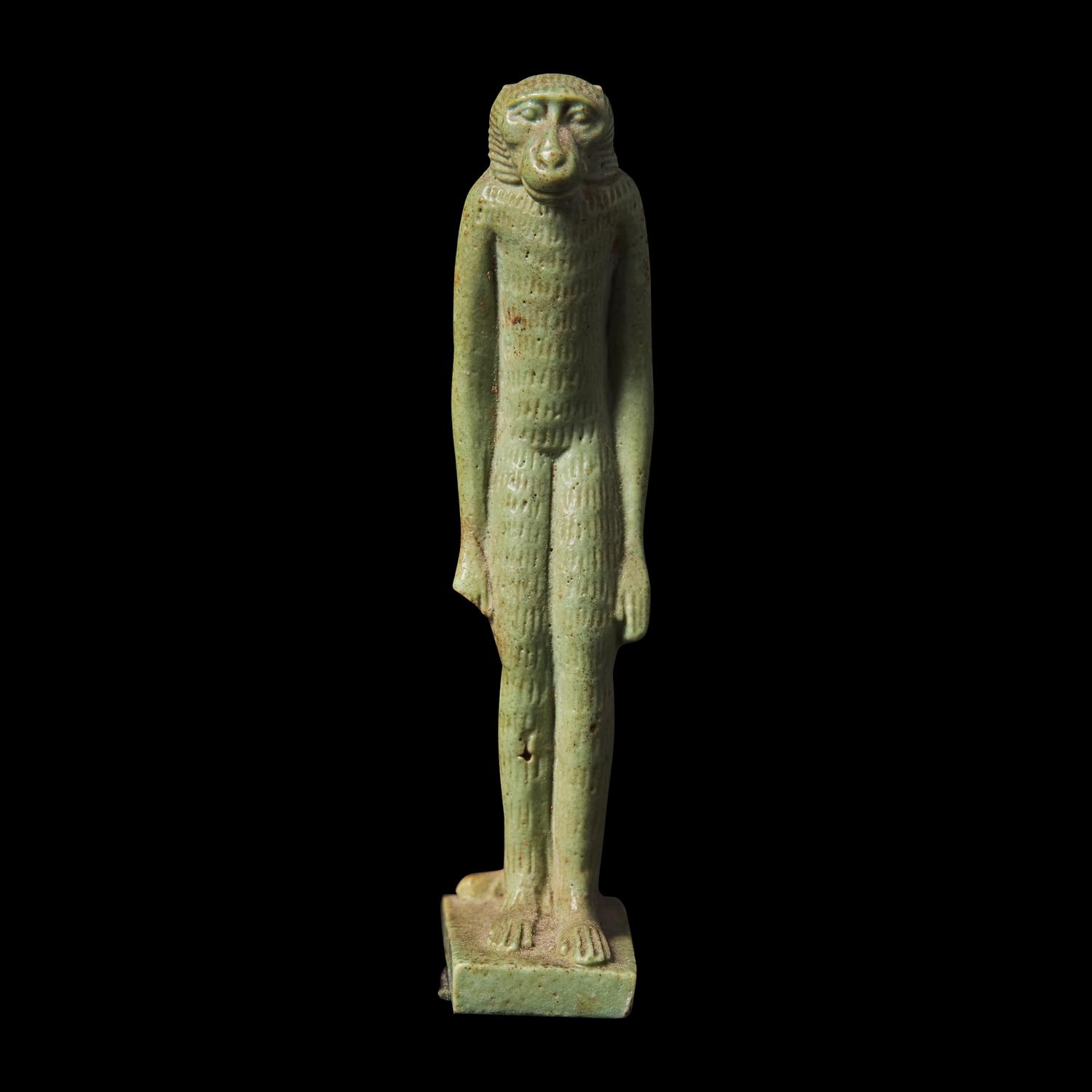An Egyptian Green Faience Baboon Amulet