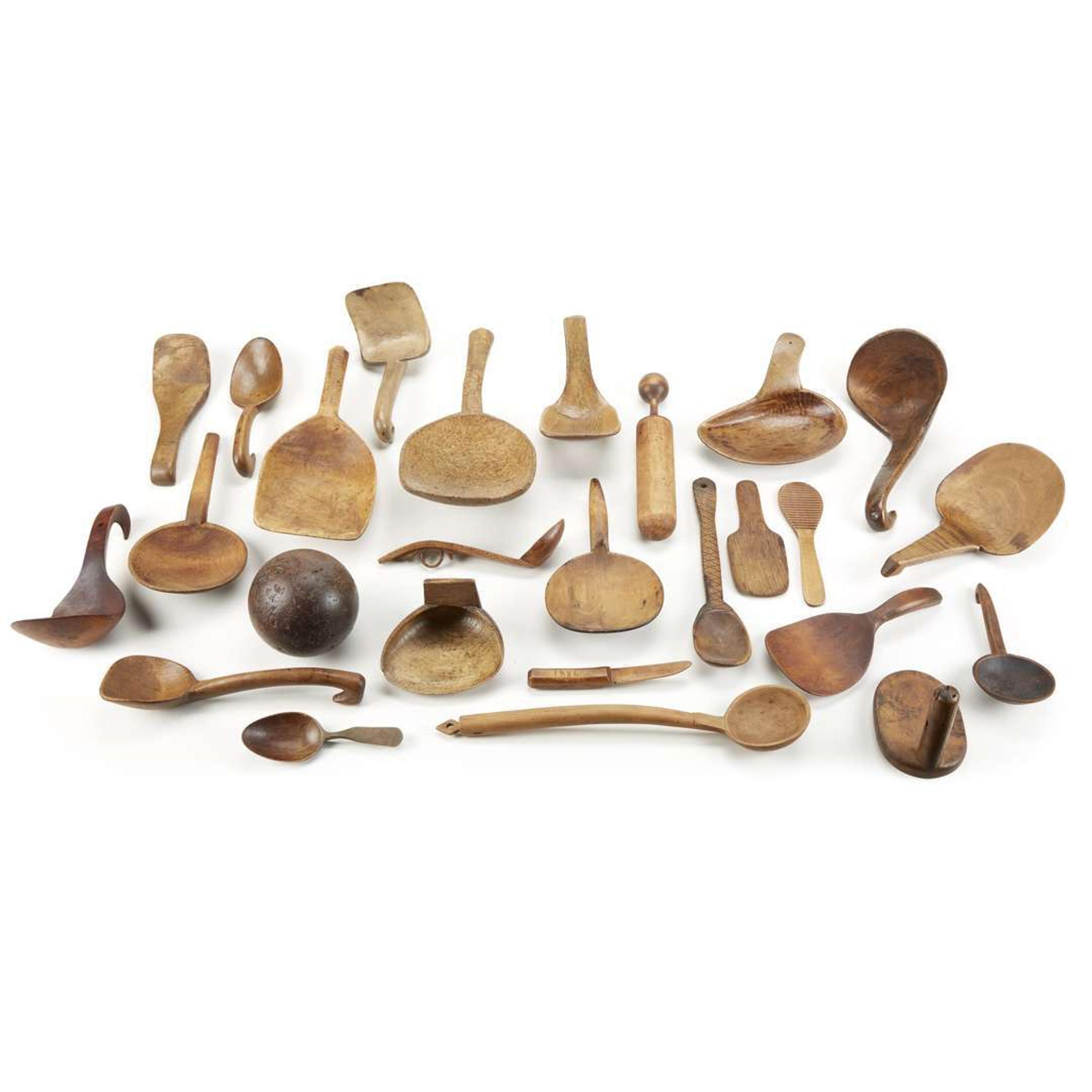 Collection of twenty-four carved and burlwood spoons, ladles, and kitchen implements Most 19th century