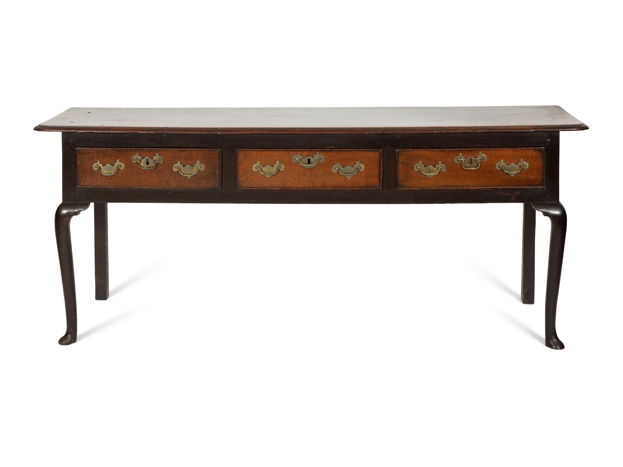 A Queen Anne Oak Three Drawer Sideboard