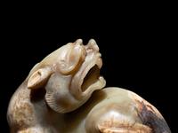 A Chinese Celadon Jade Figure of a Recumbent Bixie