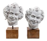 Two White Glazed Terra Cotta Heads of Bacchus Height of first 16 1/2 inches.