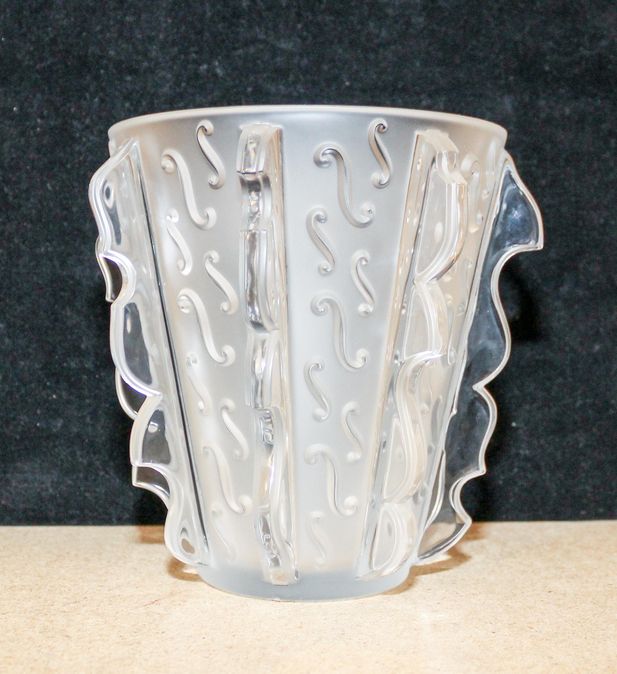 A Lalique Molded and Frosted Glass Vase. Height 7 1/4 inches.