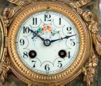 A French Metal and Onyx Clock Garniture with Figure after Francois Moreau (French, 1832-1927)