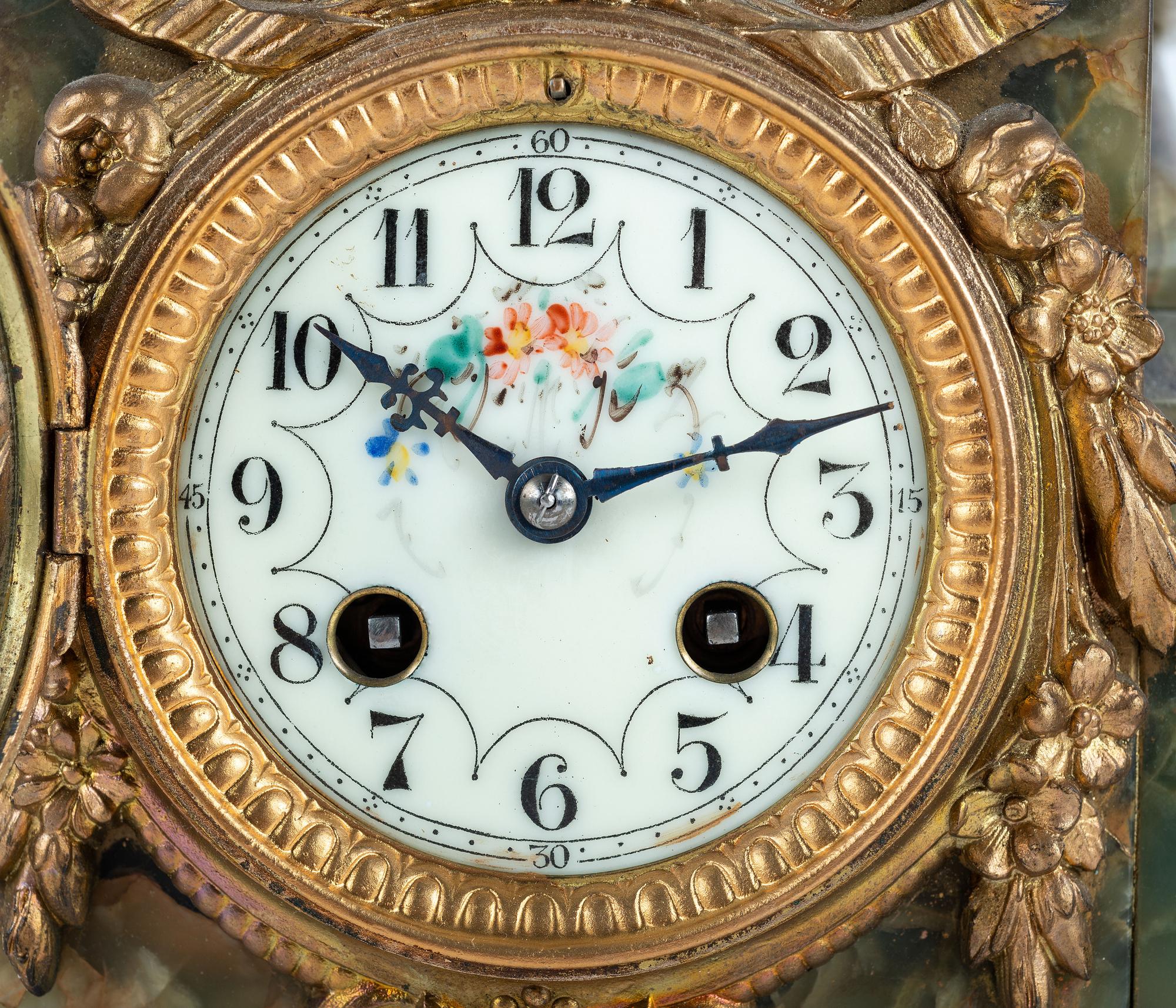A French Metal and Onyx Clock Garniture with Figure after Francois Moreau (French, 1832-1927)