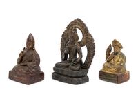 Three Sino-Tibetan Carved Wood Seated Figures