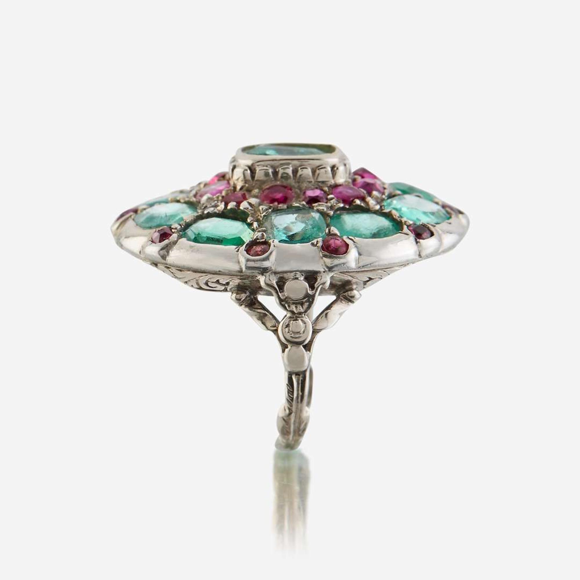 A green beryl, ruby, and ten karat white gold ring