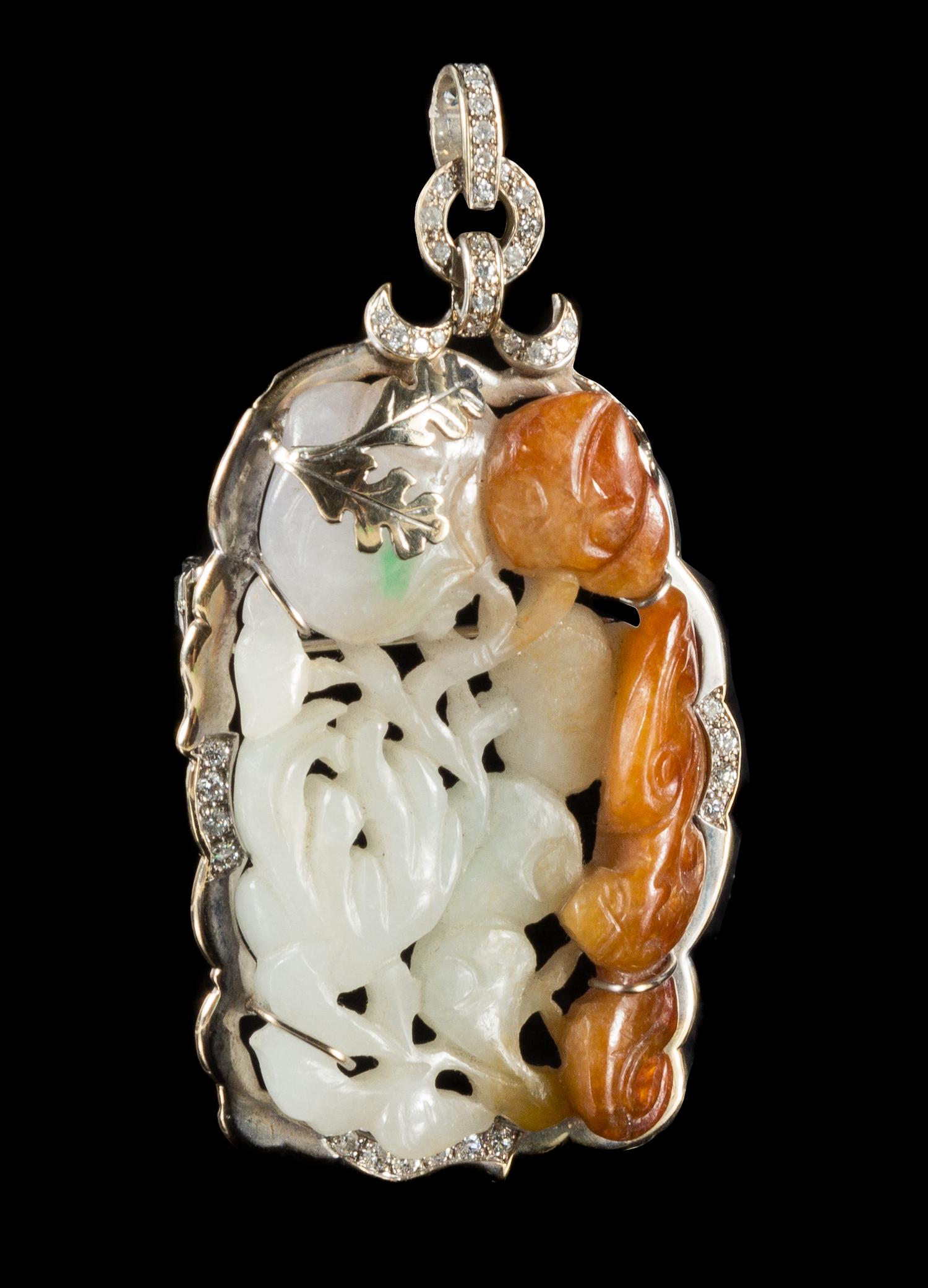 A Carved Jadeite Pendant Length 2 1/2 inches.