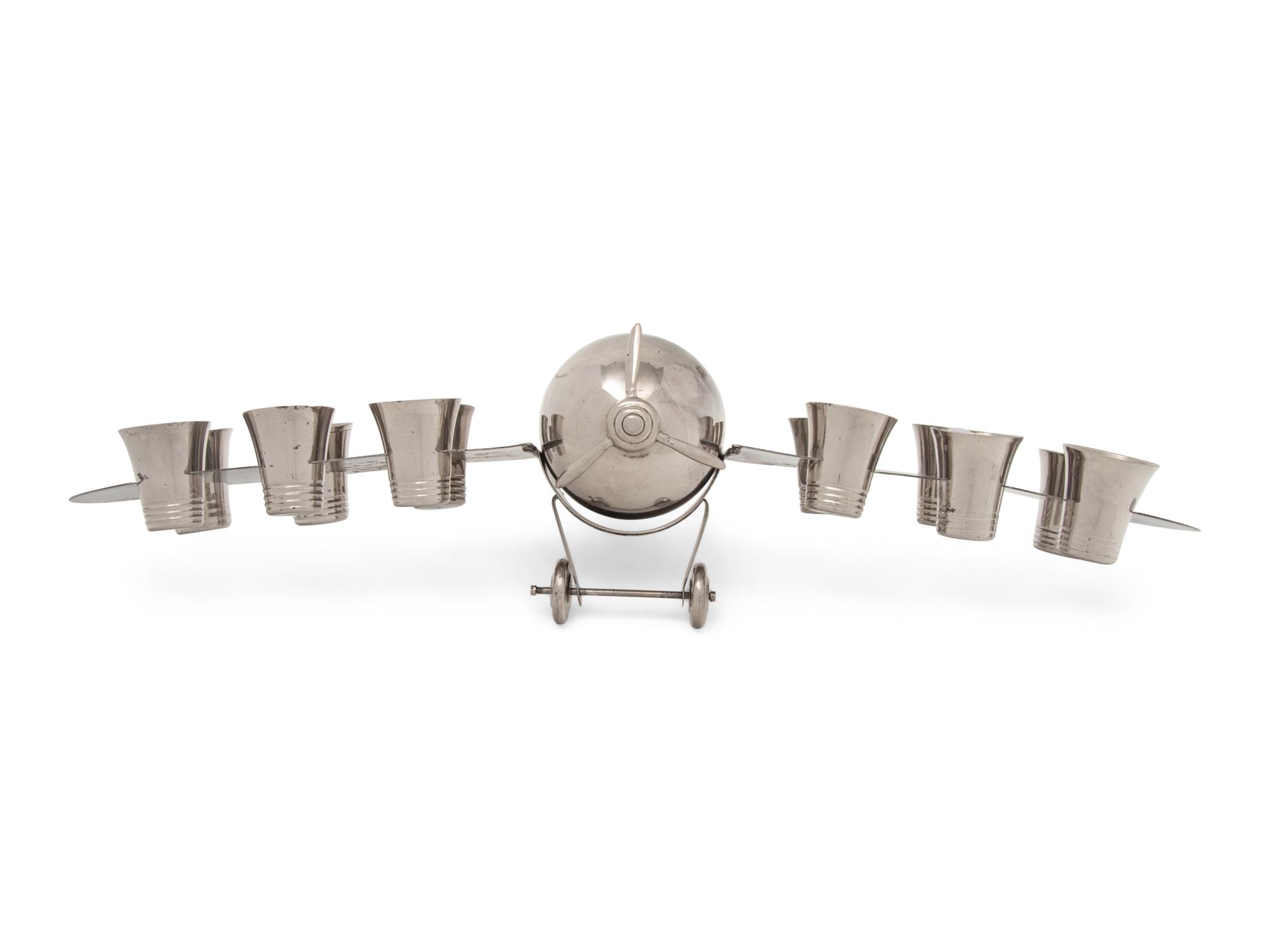 A Silver-Plate Airplane-Form Cocktail Shaker and Shot Glass Set